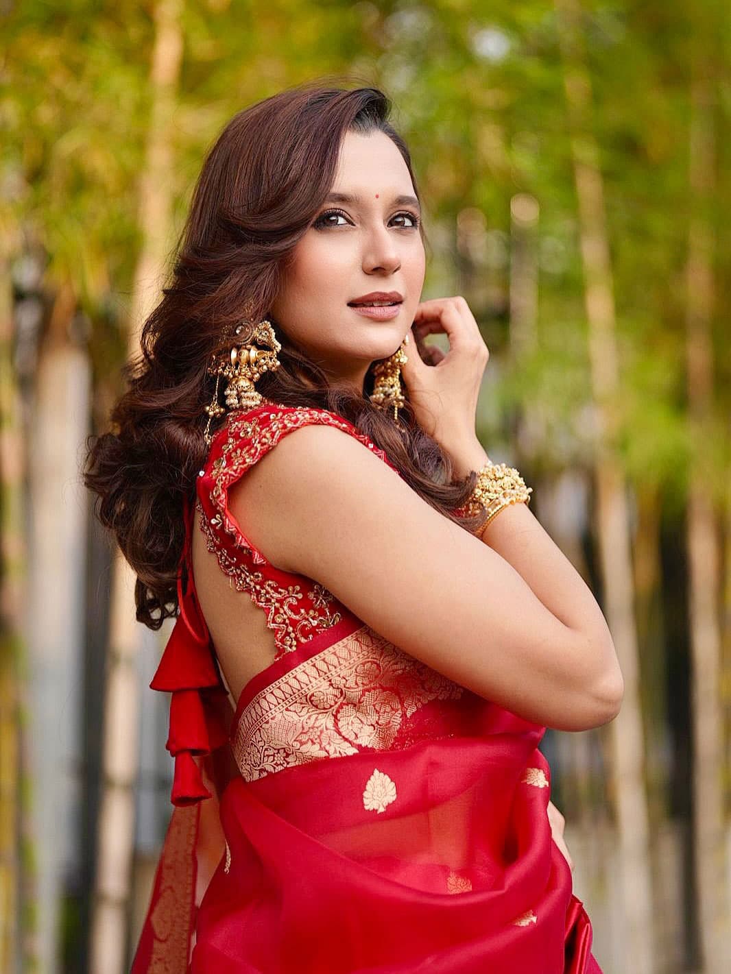 কারুকাজ করা ব্যাকলেস লাল ব্লাউজের সঙ্গে সোনালি পাড় ও বুটির লাল শাড়িতে সেজেছেন সাবিলা নূর।